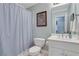 Standard bathroom with blue striped shower curtain, and white fixtures at 10275 Worthington Mnr, Suwanee, GA 30024