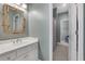 Bathroom featuring single sink vanity and bamboo framed mirror at 10275 Worthington Mnr, Suwanee, GA 30024