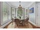 Dining room with bay windows, white trim, chandelier, and seating for six at 10275 Worthington Mnr, Suwanee, GA 30024