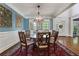 Formal dining room with wainscoting, chandelier, and large table at 10275 Worthington Mnr, Suwanee, GA 30024