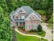 Charming two-story brick home with a cozy front porch and beautifully manicured landscaping, creating inviting curb appeal at 10275 Worthington Mnr, Suwanee, GA 30024