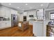 A kitchen features an island, stainless steel appliances, and white cabinets at 10275 Worthington Mnr, Suwanee, GA 30024