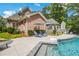 A swimming pool surrounded by lush greenery and lounge chairs at 10275 Worthington Mnr, Suwanee, GA 30024