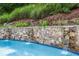 Stone wall featuring a waterfall flowing into a pool at 10275 Worthington Mnr, Suwanee, GA 30024