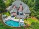 Backyard aerial view showcasing a pool, hot tub, deck, and manicured lawn at 10275 Worthington Mnr, Suwanee, GA 30024