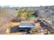 An overhead view of the home nestled in a wooded lot with outbuildings at 1315 Woodland Sw Dr, Oxford, GA 30054