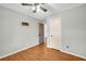 Bedroom featuring a ceiling fan, wood flooring, and a closet at 1315 Woodland Sw Dr, Oxford, GA 30054