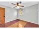 This bedroom features a ceiling fan and a window with a view of the outdoors at 1315 Woodland Sw Dr, Oxford, GA 30054