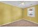 Bedroom showcasing carpeted flooring, a ceiling fan, and a window at 1315 Woodland Sw Dr, Oxford, GA 30054