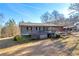 Charming ranch home featuring a spacious porch and classic architectural details on a sunny day at 1315 Woodland Sw Dr, Oxford, GA 30054