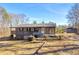 Charming ranch home featuring a spacious porch and classic architectural details on a sunny day at 1315 Woodland Sw Dr, Oxford, GA 30054