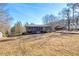 Charming ranch home featuring a spacious porch and classic architectural details on a sunny day at 1315 Woodland Sw Dr, Oxford, GA 30054