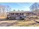 Charming ranch home featuring a spacious porch and classic architectural details on a sunny day at 1315 Woodland Sw Dr, Oxford, GA 30054