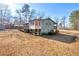 Back of home with sunroom and expansive yard, offering tranquil outdoor space at 1315 Woodland Sw Dr, Oxford, GA 30054