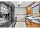 Functional kitchen featuring a black refrigerator, ample counter space, and a stainless steel sink at 1315 Woodland Sw Dr, Oxford, GA 30054