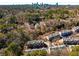 Aerial view showcasing townhouse community surrounded by trees and the city skyline at 2251 Limehurst Ne Dr, Atlanta, GA 30319