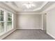 Light-filled bedroom boasts plush carpeting, a tray ceiling, and an open doorway at 2251 Limehurst Ne Dr, Atlanta, GA 30319