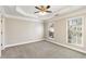 Neutral bedroom features a tray ceiling and large windows offering plenty of natural light at 2251 Limehurst Ne Dr, Atlanta, GA 30319