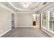 Bright bedroom features neutral carpet, tray ceiling, and natural light from large windows at 2251 Limehurst Ne Dr, Atlanta, GA 30319