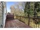 Wood deck with railing providing a private outdoor space, surrounded by mature trees and foliage at 2251 Limehurst Ne Dr, Atlanta, GA 30319