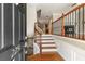 Inviting entryway featuring hardwood floors, staircase with wood and iron railings, and view into the living spaces at 2251 Limehurst Ne Dr, Atlanta, GA 30319