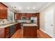 Stylish kitchen featuring stainless steel appliances, center island, granite counters, and wood cabinets at 2251 Limehurst Ne Dr, Atlanta, GA 30319