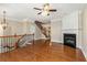 Open living area with fireplace, hardwood floors, stairs, and chandelier, offering comfortable living space at 2251 Limehurst Ne Dr, Atlanta, GA 30319