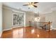 Spacious living area with gleaming hardwood floors, large window, modern fan, and elegant light fixture at 2251 Limehurst Ne Dr, Atlanta, GA 30319