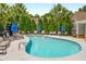 Inviting community pool with lounge chairs and blue umbrellas at 2251 Limehurst Ne Dr, Atlanta, GA 30319