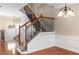 Elegant staircase features wrought iron spindles, hardwood railings, and wainscoting, leading to the upper level at 2251 Limehurst Ne Dr, Atlanta, GA 30319