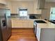 Clean kitchen space, featuring stainless steel appliances, white cabinets, and light countertops at 3868 Demooney Rd, Atlanta, GA 30349