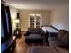 Cozy living room featuring hardwood floors, comfortable seating, and a view of the backyard through French doors at 3868 Demooney Rd, Atlanta, GA 30349