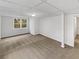 Unfinished basement area with carpeted floor and natural light from the window at 4254 Timber Trace Rd, Loganville, GA 30052