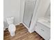 Bathroom featuring updated flooring, a toilet, a walk-in shower, and a vanity at 4254 Timber Trace Rd, Loganville, GA 30052