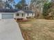 Charming single-story home with a well-maintained lawn, attached garage, and manicured landscaping at 4254 Timber Trace Rd, Loganville, GA 30052