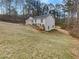 Well-maintained home with an attached garage, surrounded by lush greenery and mature trees at 4254 Timber Trace Rd, Loganville, GA 30052