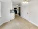 Open kitchen layout with tile flooring, view of appliances, and an entry door at 4254 Timber Trace Rd, Loganville, GA 30052