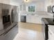 Modern kitchen with stainless steel appliances, white cabinets, and ample counter space at 4254 Timber Trace Rd, Loganville, GA 30052