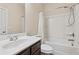 Neutral bathroom with shower-tub combo, dark-wood vanity and sleek chrome fixtures at 590 Palm Springs Cir, Fairburn, GA 30213