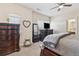 Beautiful bedroom featuring dark wood furniture, neutral walls, and a ceiling fan at 590 Palm Springs Cir, Fairburn, GA 30213