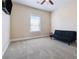 Carpeted bedroom with ceiling fan and black futon at 590 Palm Springs Cir, Fairburn, GA 30213