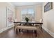 Bright dining area with a modern table set, bench, and a view of the backyard at 590 Palm Springs Cir, Fairburn, GA 30213