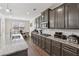 Modern kitchen features stainless steel appliances, granite countertops, and a dining area with natural light at 590 Palm Springs Cir, Fairburn, GA 30213