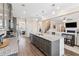 Open kitchen with a center island, stainless appliances, and a view into the living room at 590 Palm Springs Cir, Fairburn, GA 30213