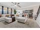 Open concept living room, connected to kitchen, featuring lots of seating and natural light at 590 Palm Springs Cir, Fairburn, GA 30213