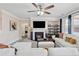 Comfortable living room featuring a fireplace, ceiling fan, and lots of natural light at 590 Palm Springs Cir, Fairburn, GA 30213