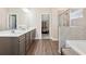 Bright main bathroom featuring double sinks, walk-in shower, and access to a walk-in closet at 590 Palm Springs Cir, Fairburn, GA 30213