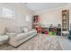 Comfortable sitting area with a neutral sofa, soft rug, and display shelving at 590 Palm Springs Cir, Fairburn, GA 30213