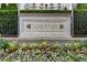Close-up view of the 'Mayfair' sign, complemented by blooming flowers and greenery at 199 14Th Ne St # 1704, Atlanta, GA 30309
