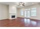 Bright living room with hardwood floors, ceiling fan, fireplace, and doors to outside at 2017 Grove Field Ln, Marietta, GA 30064